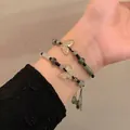 Stacked green bead bracelets with carved butterfly charms and black woven cord - New Chinese Style Butterfly Beaded Bracelet