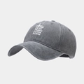 Macro detail of washed dark gray cotton baseball cap with printed religious text - Adjustable / Gray