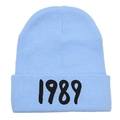 Detailed close-up of the black 1989 embroidery on a light blue knit beanie hat - Adult (Stretchy) / Sky Blue