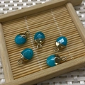 Five blue turquoise teardrop pendants with gold metal caps on a bamboo tray - No.22 Turquoise Color