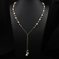 Long Y-shaped gold necklace featuring natural baroque pearls on a black jewelry bust - Adjustable Wrap Sweater Chain