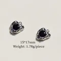 Macro detail of 15x17mm silver alloy cross wing pendant with faceted black gemstone - 7# Black Zirconia Heart