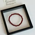 Artistic zen-style beaded bracelet featuring polished deep red natural agate stones - Cinnabar Circle