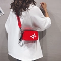 Red patent leather crossbody bag with white 'W' print and adjustable wide nylon strap - Red