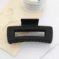 Close-up of a large matte black square hair claw clip on a minimalist aesthetic background - Black