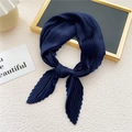 Dark blue pleated square scarf tied in a bow on a textured minimalist background - Navy Blue