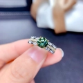 Macro view of a large green gemstone ring with triple-row pavé diamond band setting - Adjustable Open / Olive Green