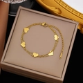 Elegant double-layered golden stainless steel heart pendant bracelet for women on jewelry box - Gold Stainless Steel Double Heart Bracelet (SLE2023)