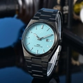 Macro shot of light blue waffle dial on PRX watch with silver hands and calendar window - 2-Black Case Light Blue Dial