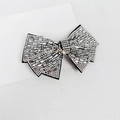 Detailed close-up of a silver bow hair clip fully encrusted with sparkling white crystals - 8cm Medium White Glass Rhinestone