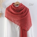 Solid red wrinkled cotton linen scarf with frayed edges hanging on a wooden hanger - Red