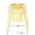 Detail of light yellow long sleeve top with ruffle heart neckline and ribbed texture - S / Yellow