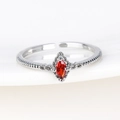 Macro shot of silver twisted band ring with a marquise-cut red zircon on white ceramic - Red Marquise Gemstone White Gold Style (Style 3 White Gold)