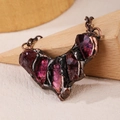 Macro shot of vintage pendant necklace with raw purple stones in copper metal casing - Amethyst Smile Chain / Amethyst