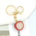 Detailed view of red and white rhinestone lychee keychain with gold metal d-ring and loop - Red and White Rhinestone Lychee