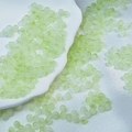 Detail of light green frosted glass beads for DIY jewelry making on white ceramic tray - Light Green Two-tone Beads (6mm)