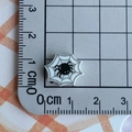 Mini resin spider web charm with 1.5 cm diameter shown on measurement grid - Spider Web