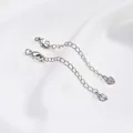 Close-up of platinum-plated extender chain with lobster clasp and heart pendant for DIY jewelry - White Gold Color Embossed Heart