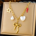 Detail of necklace featuring star, baroque pearl, red chili and bow charm accents - Star Pearl Chili Heart Bow Style (N3261)