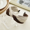 Detail of elegant knot headband in coffee and beige two-tone fabric on a glass stand - Dark Coffee and White