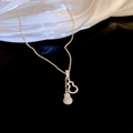 Gourd-shaped zircon and pearl necklace in gold finish on black background - Gourd Pendant Necklace