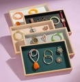 Close-up of wooden jewelry display trays with various colored velvet linings and frames - Empty Tray