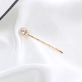 Detailed view of a gold hair clip with a large rhinestone surrounded by white pearls - Round Pearl Rhinestone