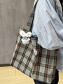 Detail view of plaid mini bag with white plush bear charm on a shoulder strap - Plaid Tote Bag
