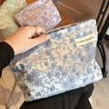 Light blue lace embroidery makeup bag with floral patterns and a woven logo label - Embroidery Blue