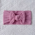 Close-up of pink nylon baby headband showing soft ribbed texture and large bow detail - Taro Purple