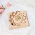 Macro view of assorted jewelry including rose gold rings and brooch on wood tray - Natural Wood Medium Square (10x10cm)
