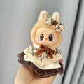 Labubu doll in brown plush hoodie and polka dot dress with a cute bow decoration - Colorful Plaid Pendant Fragrance / First And Second Generation Keychains Are Compatible With La Cloth Dolls. Dolls Not Included.
