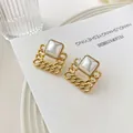 Elegant geometric square gold chain earrings with white inlay on a minimalist card - Gold with White