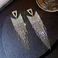 Macro shot of silver tassel earrings with sparkling rhinestones on dark leather background - Silver Geometric Trapezoid Ball Tassel (433)