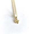 Detailed shot of a minimalist gold letter H pendant necklace with a polished finish - Letter H