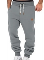 Detail view of men's gray joggers showing the drawstring waist and ribbed cuffs - Light Gray
