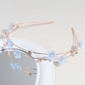 Close-up of double-layer rose gold headband with light blue flowers and shiny rhinestones - Blue