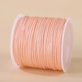 0.8mm light pink nylon cord for DIY jewelry braiding on a white plastic spool - Peach