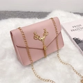 Chic pink crossbody chain bag featuring a gold deer head charm and tassel detail - Pink