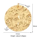 Close-up of golden hammered texture round pendant with 31mm width and 5mm top loop - Textured Disc / Gold