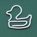 Creative duck-shaped white metal paperclip on a dark green background for office use - White