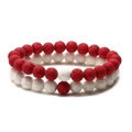 Detail of red and white lava stone beads with porous texture on elastic cord bracelets - Red