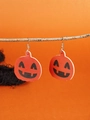 Detailed view of orange pumpkin earrings with Jack-O-Lantern faces on a branch background - WS09-5 (Orange Pumpkin Face)