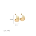 Detailed view of gold textured hoop earrings with dimensions 30.2mm by 18.9mm - Large Twill Water Drop / Gold