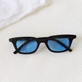 Close-up of vintage black square cat-eye sunglasses with translucent blue lenses - Black Frame Blue Lens