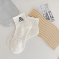 White cotton ankle socks featuring black cartoon embroidery and ribbed elastic cuffs - White Black Figure