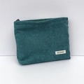 Detail of dark green corduroy makeup bag featuring a zipper and May Rabbit fabric label - Dark Green