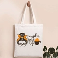 Detail of canvas tote bag featuring pumpkin spice life graphic and brown woman silhouette - Pumpkin Spice Life Drink Style