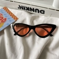 Detail of retro cat eye sunglasses with thick black frames and orange tinted lenses - Cat Eye / Black Frame Orange Lens