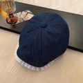 Detail of dark blue denim newsboy cap featuring elegant white lace trim on the brim - Dark Blue Lace Trim